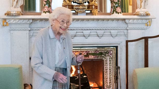 Final photo of the Queen, smiling inside the Drawing Room at Balmoral as she waited to greet Liz Truss